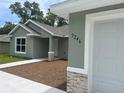 Close-up of house number on a well-maintained home with stone accents and neutral exterior paint at 8795 Juniper Rd, Ocala, FL 34480