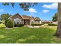 Inviting home with stone facade, well-maintained landscaping and healthy green lawn at 9641 Se 70Th Ter, Ocala, FL 34472