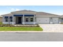 Well-maintained home with a three-car garage, fresh landscaping, and a manicured lawn at 10045 Sw 82Nd Place Rd, Ocala, FL 34481