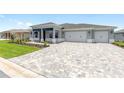 Beautiful home with a three-car garage and a spacious paver driveway at 10045 Sw 82Nd Place Rd, Ocala, FL 34481