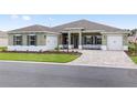 Charming single-story home with a well-manicured lawn, driveway, and a two-car garage at 10561 Sw 98Th Pl, Ocala, FL 34481