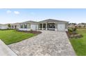 Charming single-story home with a well-manicured lawn, a driveway, and a two-car garage at 10561 Sw 98Th Pl, Ocala, FL 34481