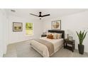 Bedroom featuring neutral decor, ceiling fan, a bright window, and soft, comfortable bedding at 1083 Sw Winding Hills Rd, Dunnellon, FL 34431