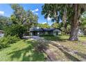 This single-story home has a beautifully landscaped yard with mature trees providing lots of shade and curb appeal at 11430 Se 54Th Ave, Belleview, FL 34420