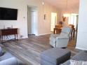 Cozy living room showcasing new vinyl plank flooring that flows into the dining area and kitchen at 11470 Sw 139Th St, Dunnellon, FL 34432
