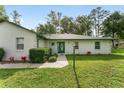 Inviting entrance featuring a green door and manicured landscaping at 12681 Se 54Th Ave, Belleview, FL 34420