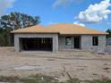 Unfinished concrete block home with exposed wood roofing being built in a sunny, undeveloped neighborhood at 13322 Sw 85 Cir, Ocala, FL 34473