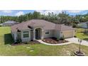 Lovely single-story home showcasing its well-kept lawn and charming, neutral-toned facade at 13741 Sw 73Rd St, Ocala, FL 34481