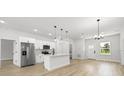 Open-concept kitchen with stainless steel appliances and bright living area with lots of natural light at 13780 Sw 42Nd Court Rd, Ocala, FL 34473