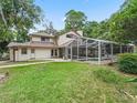 Expansive backyard with a screened-in pool and well-maintained lawn at 1630 Se 29Th Ter, Ocala, FL 34471