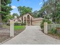 Elegant home exterior featuring manicured lawn and stately entrance columns at 1630 Se 29Th Ter, Ocala, FL 34471