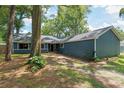 Exterior of blue home with mature landscaping and trees at 1841 Ne 38Th St, Ocala, FL 34479