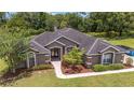 Expansive aerial view of a charming single story home with lush greenery and landscaping at 2151 Se 59Th St, Ocala, FL 34480