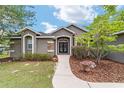 Inviting home featuring stone accents, a well-manicured yard, and a charming walkway at 2151 Se 59Th St, Ocala, FL 34480