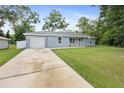 Well maintained single-Gathering home with an attached garage and long drive way at 2924 Se 142Nd Pl, Summerfield, FL 34491