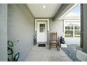 Charming front porch features stylish decor, a welcome mat, and a view of the neighborhood at 3094 Se 144Th Pl, Summerfield, FL 34491