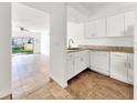 Bright kitchen with white cabinets, granite countertops, stainless steel appliances, and tile flooring at 329 Marion Oaks Blvd # A3, Ocala, FL 34473