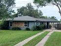 Charming single-story home with a well-manicured lawn and a brick accent wall, plus a long, private driveway at 3709 Ne 4Th St, Ocala, FL 34470
