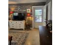 Inviting living room with stylish wood accent wall and door to exterior patio area at 3709 Ne 4Th St, Ocala, FL 34470