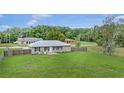 Expansive backyard featuring a lush lawn and a privacy fence, perfect for outdoor activities and relaxation at 4250 Nw 26Th Ter, Ocala, FL 34475