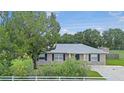 Attractive single-story home with stone features, mature trees, and a neatly kept lawn at 4250 Nw 26Th Ter, Ocala, FL 34475