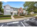 A row of townhomes features reserved parking and manicured lawns in a well-kept community at 4429 Sw 49Th Ave, Ocala, FL 34474