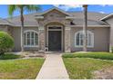 Elegant front entrance with stone pillars, double doors, and manicured landscaping at 4731 Se 34Th St, Ocala, FL 34480