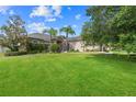 Attractive single-story house with a spacious front yard, mature trees, and lush landscaping at 4731 Se 34Th St, Ocala, FL 34480