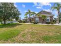 Well-kept front yard showcasing the side of a charming home with stone accents and mature trees at 4731 Se 34Th St, Ocala, FL 34480