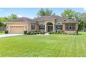 Attractive single-story home featuring a well-kept lawn and a welcoming facade at 5024 Sw 114Th Street Rd, Ocala, FL 34476