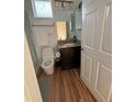 Cozy bathroom featuring a granite vanity top, wood-look flooring, and a tiled shower at 5235 Nw 33Rd Pl, Ocala, FL 34482