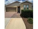 Inviting home with a brick-paved walkway leading to the front entrance and lush green landscaping at 5235 Nw 33Rd Pl, Ocala, FL 34482
