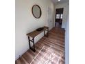 Bright hallway with wood floors featuring a console table and a view into the living room at 5235 Nw 33Rd Pl, Ocala, FL 34482