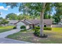Cozy single-Gathering house with a lush front yard, mature trees, and an attached garage, perfect for suburban living at 5581 Se 35Th St, Ocala, FL 34480