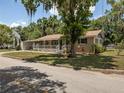 Charming single-story home with a welcoming front porch and mature landscaping at 5915 Se Holly Rd, Belleview, FL 34420