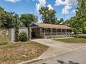 Inviting single-story home with a covered front porch and convenient carport at 5915 Se Holly Rd, Belleview, FL 34420