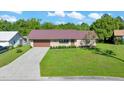 Inviting single-story brick home featuring a well-kept lawn and a durable metal roof at 6142 Se 37Th Ter, Ocala, FL 34480