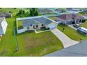 Aerial view of home showing the expansive green lawn, fenced yard, and long driveway at 7327 Sw 129Th Ln, Ocala, FL 34473