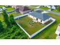 Wide shot of fully fenced backyard with mature landscaping, and a cozy fire pit area at 7327 Sw 129Th Ln, Ocala, FL 34473