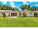 A fenced-in backyard featuring a lush green lawn, a screen porch, and mature trees at 8351 Sw 93Rd Ln # C, Ocala, FL 34481
