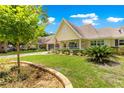 Beautiful one-story home with manicured landscaping, stone-lined flowerbeds, and a covered front porch at 8351 Sw 93Rd Ln # C, Ocala, FL 34481