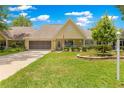 Inviting one-story home featuring a well-maintained lawn, charming front porch, and attached garage at 8351 Sw 93Rd Ln # C, Ocala, FL 34481
