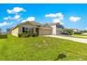 Well-maintained lawn of a one-story home with beautiful siding and a garage, alongside a two-story home at 8685 Sw 49Th Cir, Ocala, FL 34476