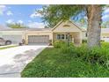 Inviting single-story home with a well-maintained lawn and a two car garage at 9085 Sw 96Th Ln # B, Ocala, FL 34481