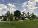 Beautiful home with a well-manicured lawn and inviting entryway with classic architectural columns at 9923 Se 64Th Ave, Belleview, FL 34420