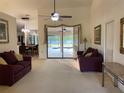 Spacious living room with plush seating and a view of the outdoor patio and pool area at 9923 Se 64Th Ave, Belleview, FL 34420