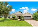 Charming single-Gathering home with a well-maintained lawn, beautiful landscaping, and a two-car garage at 9925 Sw 95Th Loop, Ocala, FL 34481