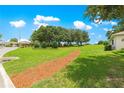 Lush green lawn with decorative mulch path and mature trees in a tranquil setting at 9925 Sw 95Th Loop, Ocala, FL 34481