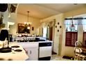Bright kitchen features essential appliances, ample counter space, and a quaint dining area by the window at 8896 Sw 116Th Place Rd, Ocala, FL 34481