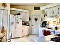 Functional kitchen with white cabinetry, essential appliances, and plenty of counter space for meal preparation at 8896 Sw 116Th Place Rd, Ocala, FL 34481